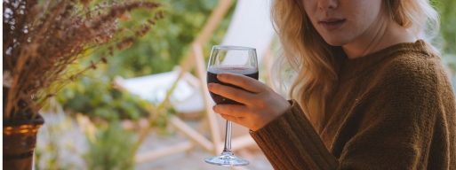Blonde woman enjoys a glass of wine on her new patio set