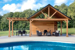 Grey poolside patio furniture set under a wooden structure