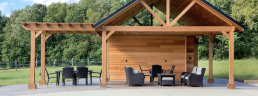 Grey poolside patio furniture set under a wooden structure